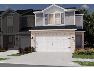 New townhome exterior featuring a two-car garage, brick accents, and stylish gray siding at 5034 Kellaher Pl, Charlotte, NC 28216