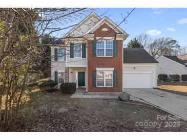 Brick and siding two-story house with green shutters and attached garage at 8018 Trotter Rd, Charlotte, NC 28216