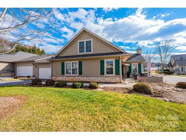 Tan house with green shutters, stone accents, and a landscaped lawn at 823 Wynnshire Dr # C, Hickory, NC 28601