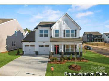 Charming two-story home features a welcoming front porch and two-car garage at 12009 Garmon Mill Estates Dr # 2P, Stanfield, NC 28163