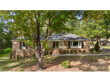 Brick ranch home with mature landscaping and walkway at 1935 Berkshire Dr, Gastonia, NC 28052