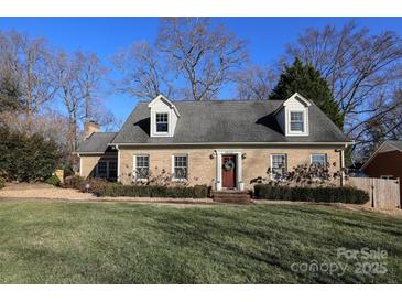 Brick ranch home with a charming front yard and mature trees at 6800 Newhall Rd, Charlotte, NC 28270