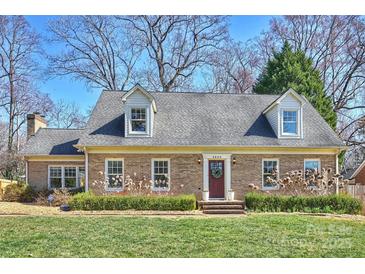 Charming brick home with a well-manicured lawn and inviting red front door at 6800 Newhall Rd, Charlotte, NC 28270