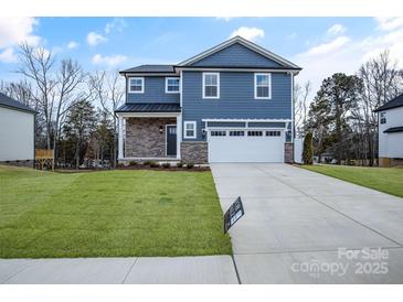 Two-story home with blue siding, stone accents, and a two-car garage at 1510 Nectar Way, Kannapolis, NC 28027