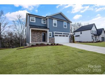 Two-story home with blue siding, stone accents, and a two-car garage at 1510 Nectar Way, Kannapolis, NC 28027