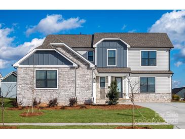 Beautiful two-story home with stone and siding, dark-frame windows, and well-manicured landscaping at 1852 Yardley St, Rock Hill, SC 29732