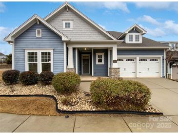 Two-story house with blue siding, stone accents, and a three-car garage at 1924 Felts Pkwy, Fort Mill, SC 29715