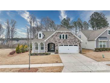 Charming craftsman style home with stone accents and a two-car garage at 201 Picasso Trl, Mount Holly, NC 28120