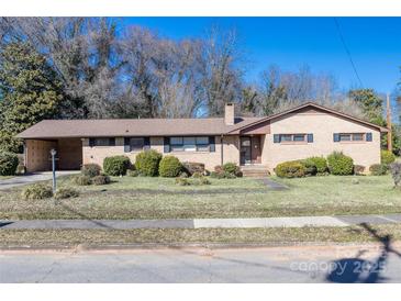 Charming ranch-style home with a well-maintained lawn and mature landscaping at 202 Cedar St, Belmont, NC 28012