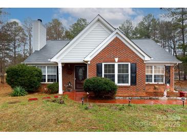 Brick ranch house with landscaped yard and a charming front porch at 234 Henson Ln, McConnells, SC 29726