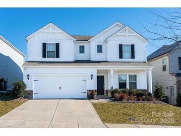 Two-story white house with black shutters, two-car garage, and landscaping at 3962 Isenhour Rd, Kannapolis, NC 28081