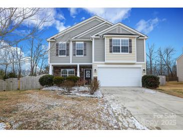 Two-story house with gray siding, stone accents, and a two-car garage at 4182 Cordell Ct, Midland, NC 28107