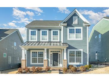 Charming two-story home featuring a welcoming front porch and beautiful architectural details at 5115 Waterloo Dr, Fort Mill, SC 29708