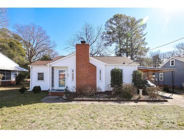 White house with brick chimney, landscaping, and carport at 617 York S Ave, Rock Hill, SC 29730