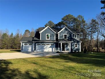 Beautiful two-story home with a three car garage and a well manicured lawn at 8768 Sherrills Ford Rd, Sherrills Ford, NC 28673