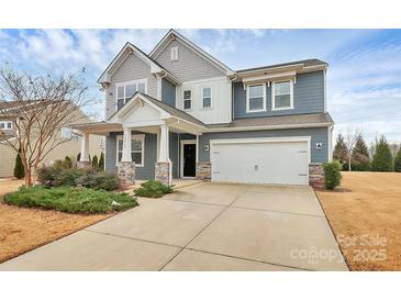 Charming two-story home with a two-car garage and a beautifully landscaped front yard at 14812 Baytown Ct, Huntersville, NC 28078