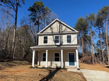 Two-story house with light beige siding, a blue door, and a small front yard at 203 Benfield Rd, Kings Mountain, NC 28086