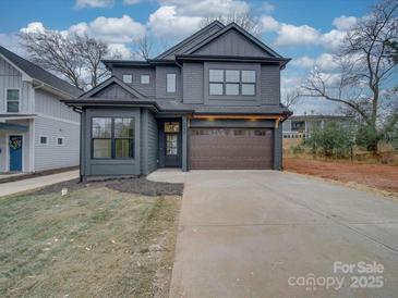 Two-story craftsman style home with gray siding and a brown garage door at 2039 Renner St, Charlotte, NC 28216