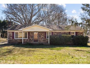 Brick ranch house with a covered porch and large yard at 214 Costner Dr, Bessemer City, NC 28016