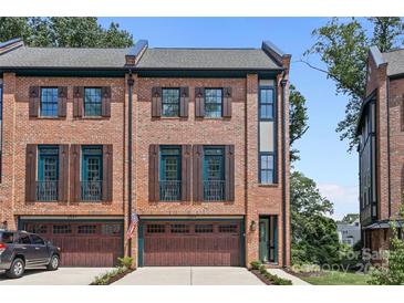 Brick front exterior of a three-story townhome with a two-car garage at 2549 Vail Ave, Charlotte, NC 28207