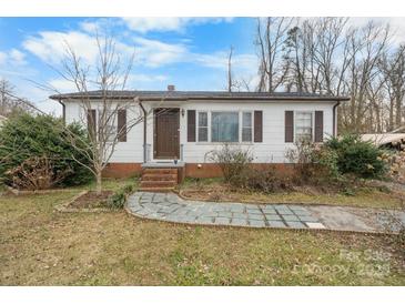 Charming single-story home with white siding, brown shutters, and a walkway leading to the front door at 2907 1St Nw Ave, Hickory, NC 28601