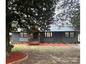 Charming one-story home with a welcoming porch and newly installed landscaping at 3027 Remington St, Charlotte, NC 28216