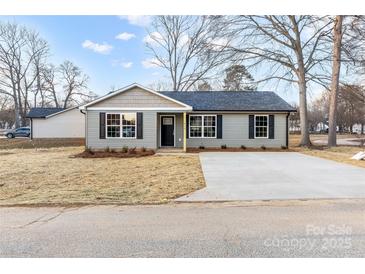 Newly constructed home with gray siding and a paved driveway at 413 Peach St, Kannapolis, NC 28083