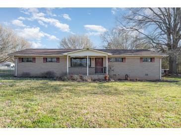 Charming one-story brick home featuring a cozy front porch and a well-maintained yard at 48780 N Us 52 Hwy, Richfield, NC 28137