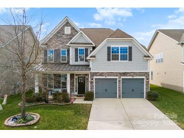 Two-story house with gray siding, stone accents, and a two-car garage at 8023 Alford Rd, Fort Mill, SC 29707