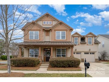 Charming two-story home featuring a welcoming front porch and well-manicured landscaping at 11138 Skytop Dr, Huntersville, NC 28078