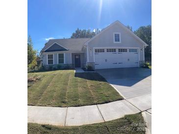 Charming single Gathering home with a manicured lawn, two-car garage, and light gray siding at 505 Grandiflora Ave, Lancaster, SC 29720