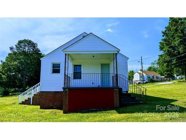 White house with red base, front porch, and steps leading to the front door at 556 6Th St, Chester, SC 29706