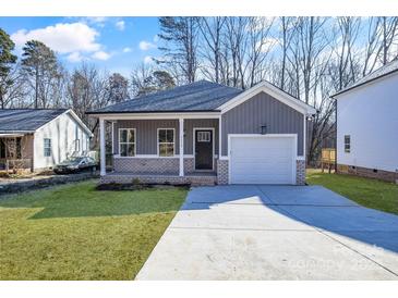 Gray exterior home with white garage door and brick accents at 5618 Pine St, Charlotte, NC 28269