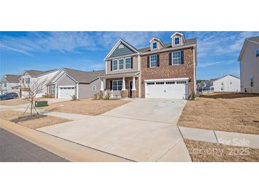 Charming home with a two-car garage, driveway, brick and vinyl siding at 7324 Teague Dr, Gastonia, NC 28056