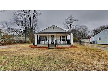 Charming white cottage with a front porch and well-maintained lawn at 105 Valley Ave, Clover, SC 29710