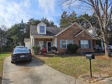 Brick ranch home with driveway, landscaping, and a spacious yard at 1657 Diary Dr, Rock Hill, SC 29732