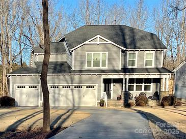 Two-story house with gray siding, three-car garage, and a long driveway at 174 Country Lake Dr, Mooresville, NC 28115