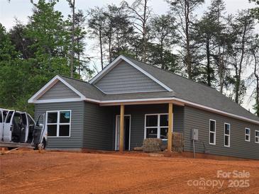 Charming one-story home with gray siding, a covered porch, and well-manicured landscaping at 211 Benfield Rd, Kings Mountain, NC 28086
