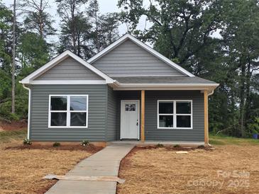 Charming gray home featuring a covered front porch, complemented by a well-manicured lawn at 211 Benfield Rd, Kings Mountain, NC 28086