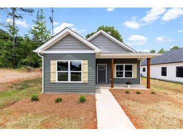 Charming single-story home with gray siding, wood accents, and a welcoming front porch at 211 Benfield Rd, Kings Mountain, NC 28086