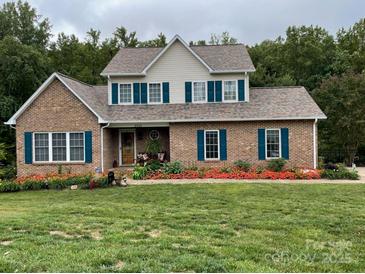 Brick house with landscaped yard and teal shutters at 2521 Whistler Ct, Newton, NC 28658