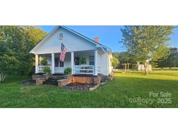 Charming white house with a front porch and landscaped yard at 2961 Great Falls Hwy, Lancaster, SC 29720