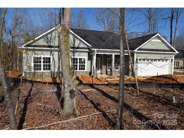 New construction home with gray siding, stone accents and a two-car garage at 3015 Buffet Ln, Monroe, NC 28110