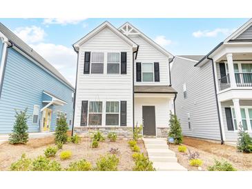 Two-story white house with black shutters, stone accents, and landscaping at 693 Candela Ct, York, SC 29745