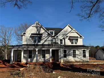 New construction featuring a charming two-story home with covered porch at 8704 Sherrills Ford Rd, Sherrills Ford, NC 28673