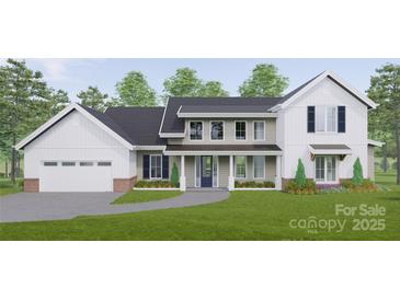 Two-story farmhouse with white and beige siding, a large garage, and landscaping at Lot #6A Otis Crosby Rd, York, SC 29745