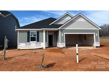 Charming single-story home featuring a two-car garage, covered entry, and horizontal siding, set on a spacious lot at 1012 Farm Branch Ct, Indian Trail, NC 28079