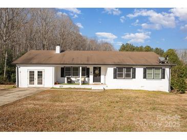 White ranch house with attached garage and a spacious yard at 1241 Red River Rd, Rock Hill, SC 29730