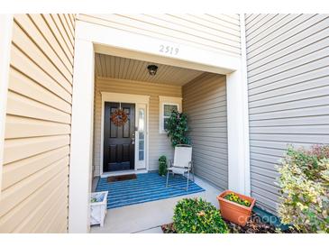 Inviting front entrance with a charming porch and landscaping at 2519 Early Flight Dr, Charlotte, NC 28262