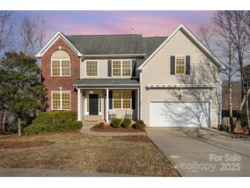 Charming two-story home with brick and siding exterior, covered porch, and well-maintained landscaping at 346 Almora Loop, Mooresville, NC 28115